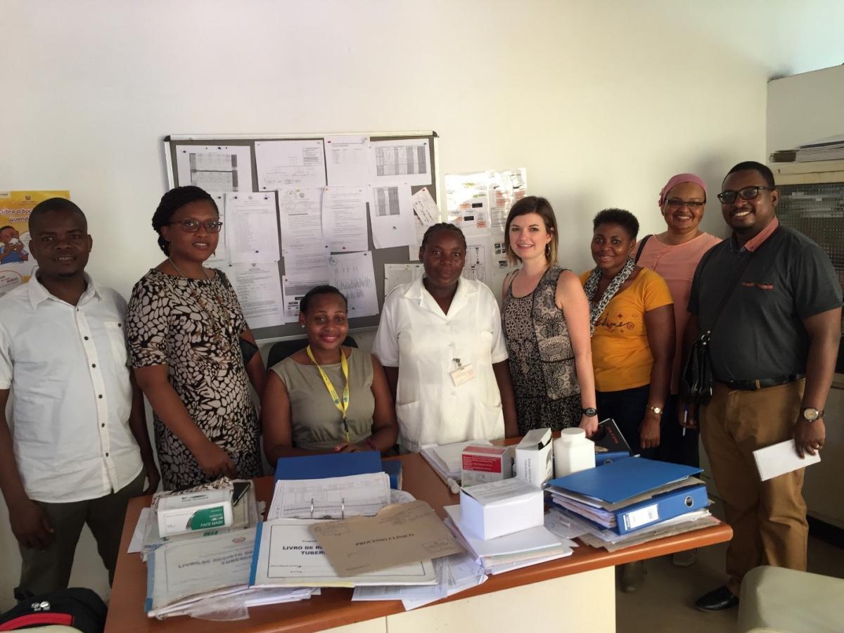 Curran with a TB nurse, TB district supervisor, and CDC and national TB program colleagues at a health facility in Mozambique. 