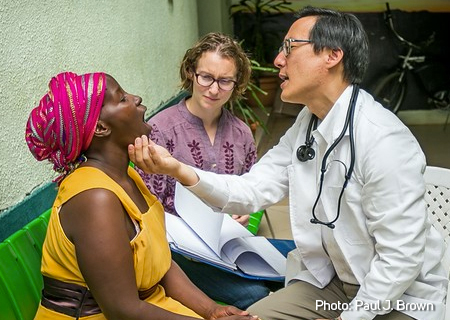 Dr. Michael Chung checks vitals of study participant while Sharon Greene asks questions to evaluate the study