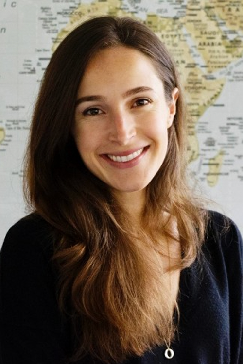 Claire Rothschild headshot in front of a world map