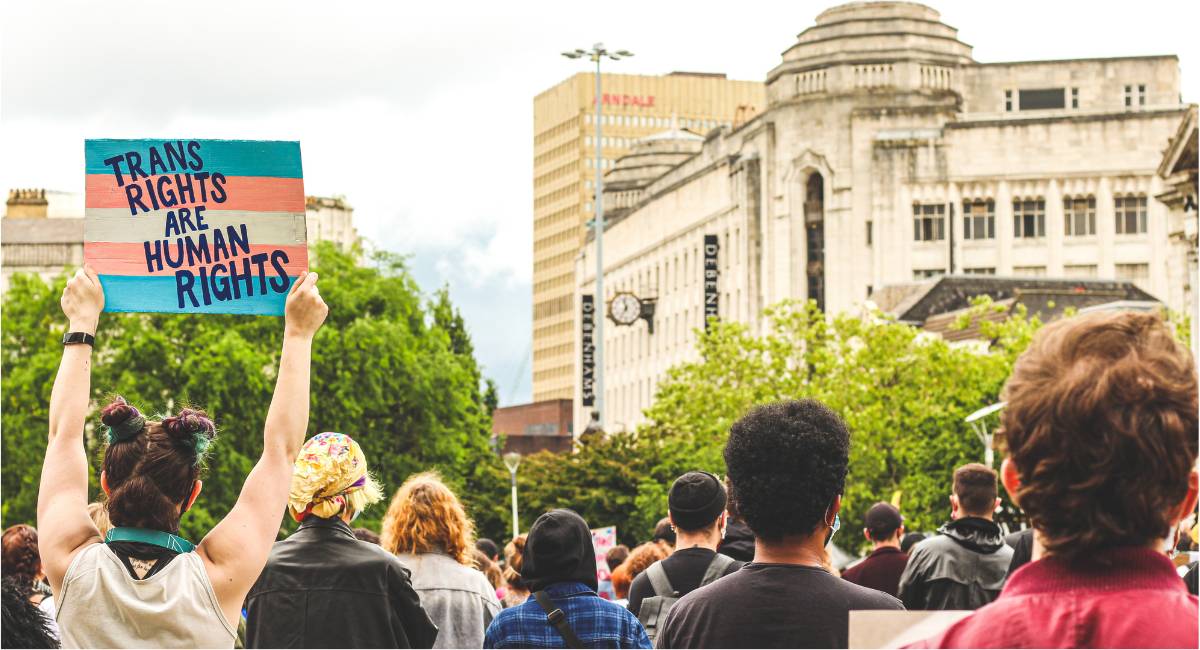 trans right activists demonstrating with a sign that reads "trans rights are human rights"